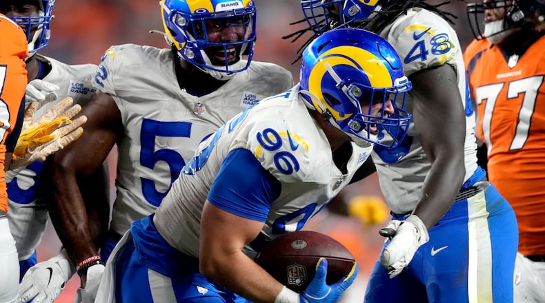Los Angeles Rams defensive lineman Mike Hoecht (96) celebrates his fumble recovery against the Denver Broncos during the first half of an NFL preseason football game, Saturday, Aug. 28, 2021, in Denver. (AP Photo/David Zalubowski)
