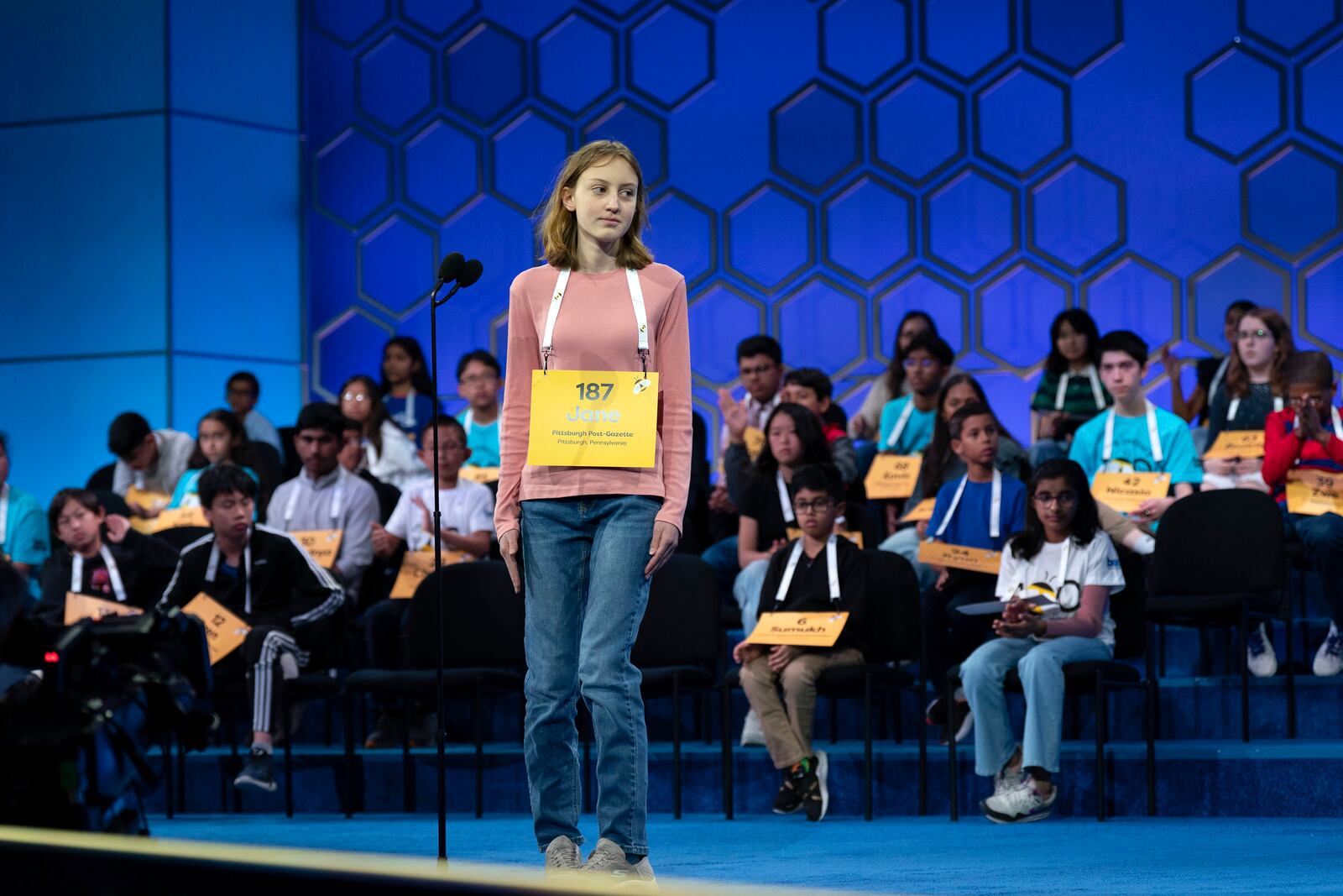 Jane Ross, 14, of Pittsburgh, Pa.,, spells her word as she competes during the quarterfinals of the Scripps National Spelling Bee at the Gaylord National Resort & Convention Center Wednesday, May 28, 2025, in Oxon Hill, Md. (AP Photo/Jose Luis Magana)