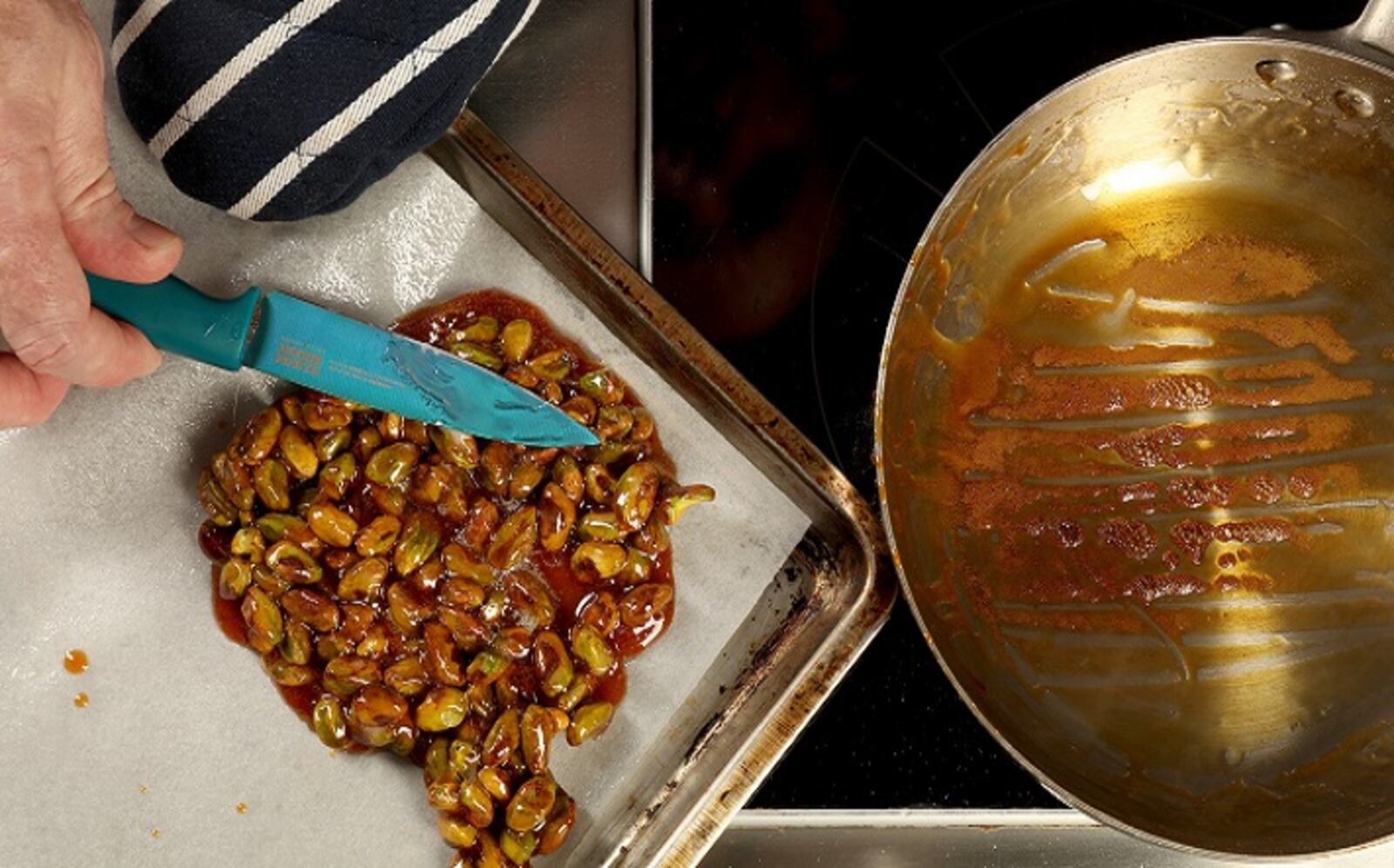 Use a buttered knife to spread the nuts out in a single layer. Allow to cool before removing from the parchment and breaking into pieces to use or store. (Michael Tercha/Chicago Tribune/TNS)