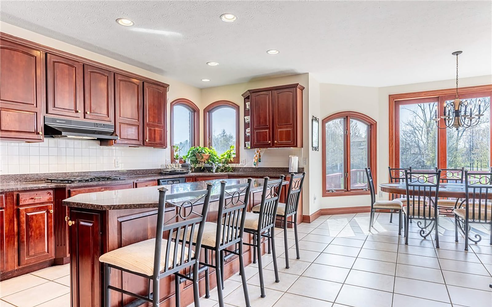 The eat in kitchen walks out to the elevated rear deck that overlooks the lake, has tile flooring and stainless appliances and wood cabinets and a breakfast bar. CONTRIBUTED