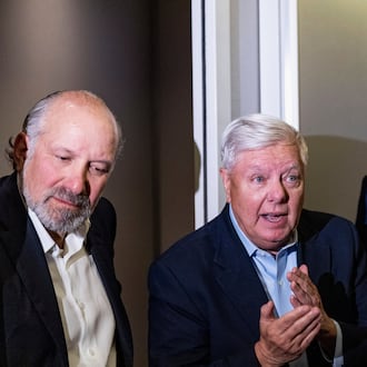 President Donald Trump, accompanied by Commerce Secretary Howard Lutnick, left, and Sen. Lindsey Graham, R-S.C., speaks with reporters while in flight on Air Force One, Sunday, Jan. 4, 2026, as returning to Joint Base Andrews, Md. (AP Photo/Alex Brandon)