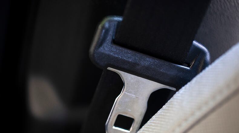A seat belt for the right front passenger seat is shown in a vehicle on Monday, Aug. 21, 2023. The Department of Transportation is proposing new rules designed to encourage seat belt use by car and truck passengers, including those sitting in the back seat. The new rules proposed by the National Highway Traffic Safety Administration would require manufacturers to equip vehicles with additional seat belt warning systems for the right front passenger and for rear seats to encourage increased seat belt use. (AP Photo/Jenny Kane)