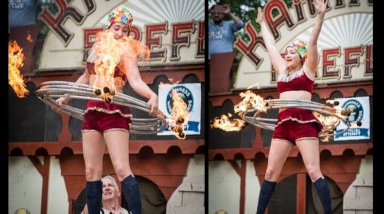 Casey Martin of the performing duo the KamiKaze FireFlies broke her own world Guinness World Record for the most flaming hula hoops on the body at the Ohio Renaissance Festival near Waynesville Sunday, Sept. 29.