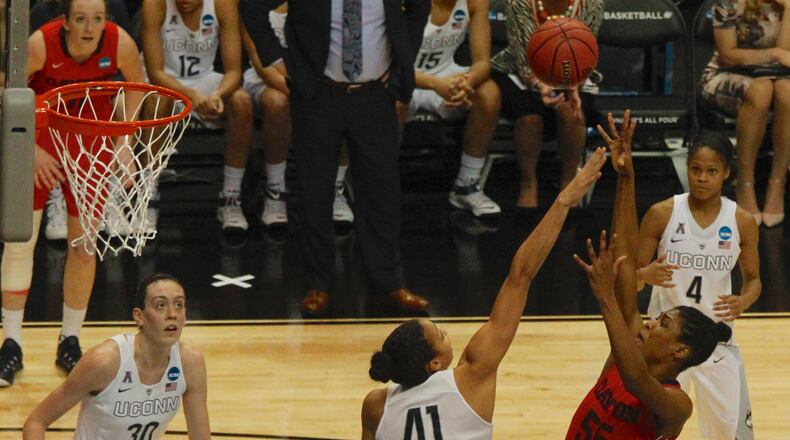 Dayton’s Saicha Grant-Allen shoots against Connecticut’s Kiah Stokes in the Albany Regional final on Monday, March 30, 2015, at the Times Union Center in Albany, N.Y. David Jablonski/Staff