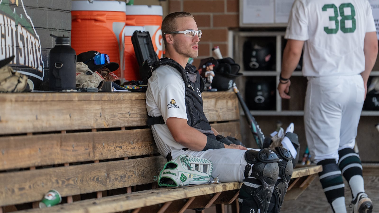 Wright State University senior catcher Boston Smith, a Vandalia Butler grad, sits in the dugout their game against Northern Kentucky University on Sunday afternoon at Nischwitz Stadium in Fairborn. JORDAN WOMMACK / CONTRIBUTED PHOTO