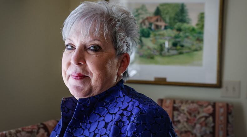 Carol Collins is the Director of Leisure Service and Horticulture for the City of Oakwood. The painting behind Collins is Smith Gardens. JIM NOELKER/STAFF