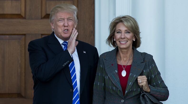 BEDMINSTER TOWNSHIP, NJ - NOVEMBER 19: (L to R) president-elect Donald Trump and Betsy DeVos pose for a photo after their meeting at Trump International Golf Club, November 19, 2016, in Bedminster Township, New Jersey. (Photo by Drew Angerer/Getty Images)