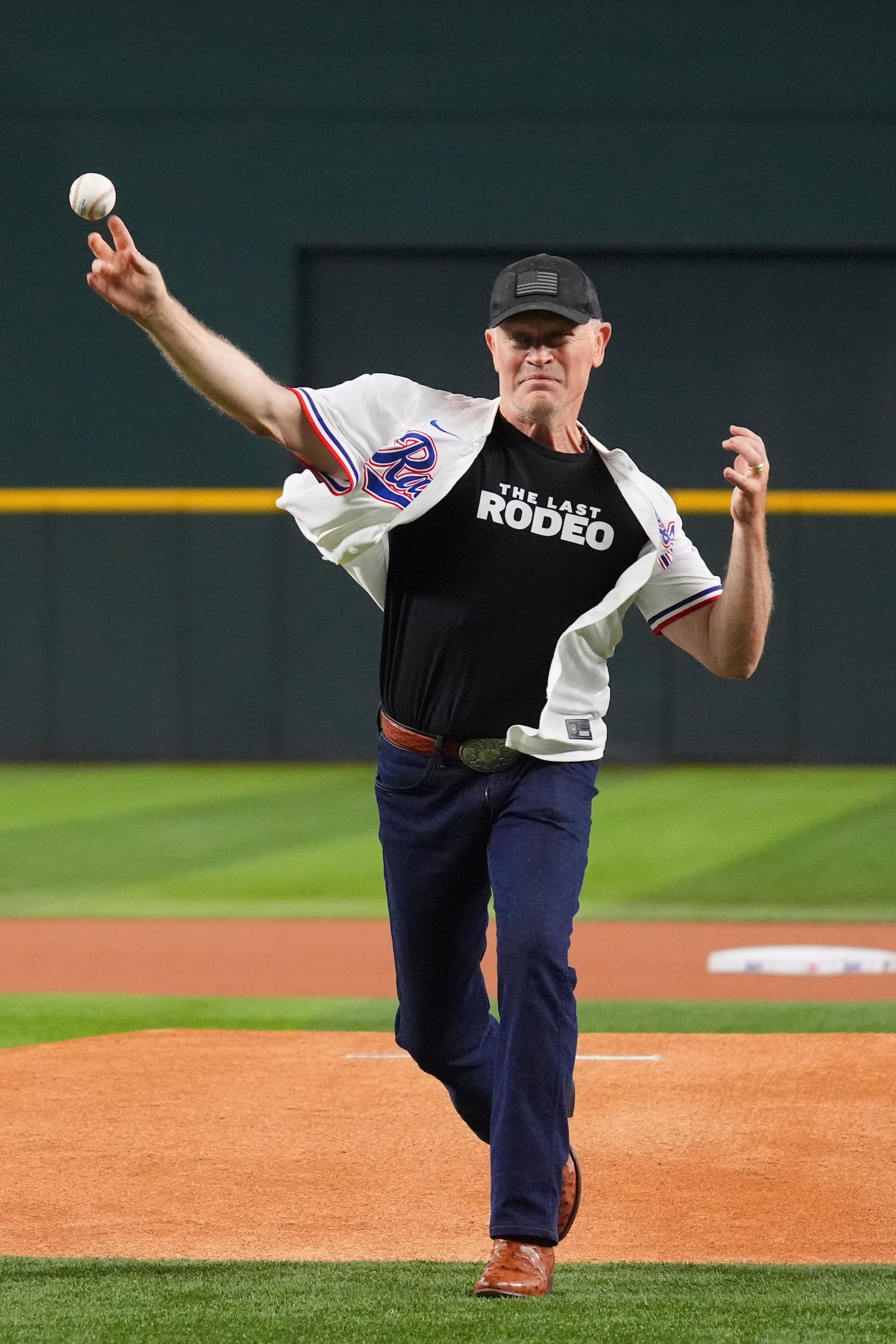 Actor Neal McDonough throws the first pitch of a baseball game between the Colorado Rockies and Texas Rangers, Wednesday, May 14, 2025, in Arlington, Texas. (AP Photo/LM Otero)