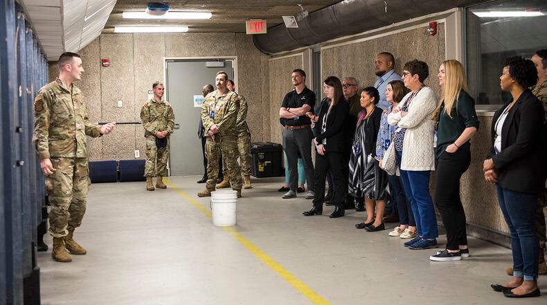 Tech. Sgt. Sawyer McIntyre (left), 88th Security Forces Squadron, leads a tour of the shooting range for LEADership Wright-Patt students on May 3 at Wright-Patterson Air Force Base. Students got a look at SFS facilities and watched a military working dog demonstration. U.S. AIR FORCE PHOTO/JAIMA FOGG