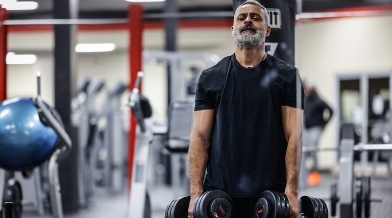 Anan Deek deadlifts free weights at Everybody Fitness on Woodman Drive in Kettering. JIM NOELKER/STAFF