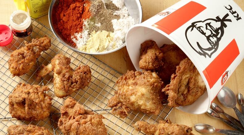 We didn't taste much of a difference between Kentucky Fried Chicken, right, and the fried chicken, left, on wire rack, we made in our test kitchen using a recipe that may - or may not - be Colonel Sanders' secret blend of 11 herbs and spices. (Michael Tercha/Chicago Tribune/TNS)
