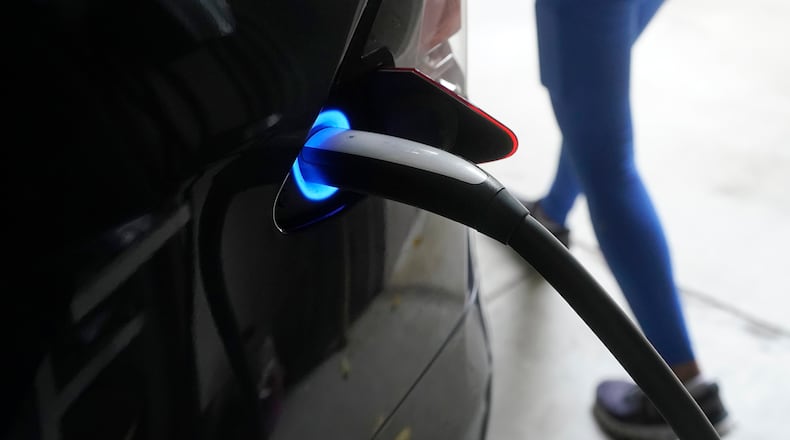 FILE - A Tesla car charges at a home in San Francisco, Aug. 25, 2022. (AP Photo/Jeff Chiu, File)