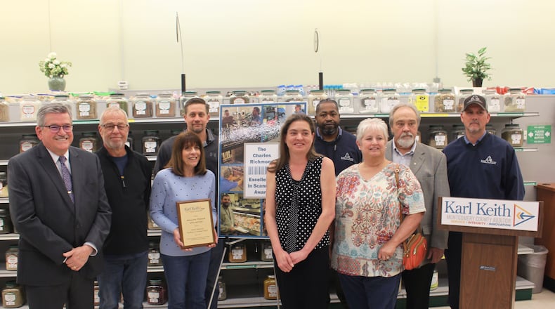 Karl Keith, Steve Wilson, John Miller, Rhonda Miller, Angie Richmond, Kathy Richmond, Joe Harris, Varney Richmond and Joe Hatton at Health Foods Unlimited as they receive the 2022 Charles Richmond Excellence in Scanning Award on May 9, 2022. Credit: Office of Montgomery County Auditor Karl Keith.