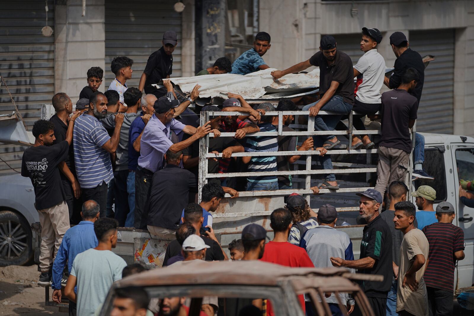 Mourners pray carry the bodies of Palestinians who were killed by an Israeli airstrike, during their funeral at Shifa Hospital in Gaza City Tuesday, July 15, 2025. (AP Photo/Jehad Alshrafi)