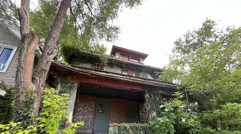 Dayton is preparing for its first round of demolition using federal COVID relief funds, and this home on the 300 block of Kenwood Avenue in the Five Oaks neighborhood will be demolished. Five blighted properties on the street will be torn down, including four on the 300 block that are decaying and covered in weeds and vegetation. CORNELIUS FROLIK / STAFF