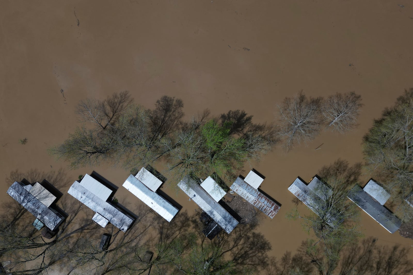 FILE - A mobile home park floods where rising waters of the Little Sugar Creek meet the Ohio River, Monday, April 7, 2025, in Napoleon, Ky. (AP Photo/Carolyn Kaster, File)