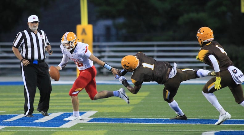 Alter's C.J. Hicks tries to tackle Fenwick's Braden Listermann on Friday, Sept. 11, 2020, at Roush Stadium in Kettering. David Jablonski/Staff