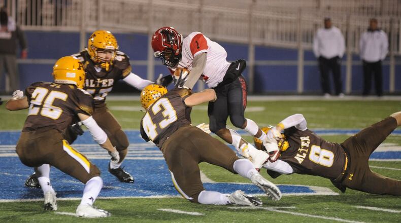 Alter defenders John Taylor (26), Mason Henry (40), Dan O’Connell (43) and Matt Schimpf (8) converge on Mt. Healthy’s Nathaniel Armstrong. Alter defeated Cin. Mt. Healthy 14-12 in a D-III, Region 12 quarterfinal high school football playoff game at Fairmont’s Roush Stadium on Friday, Nov. 2, 201. MARC PENDLETON / STAFF