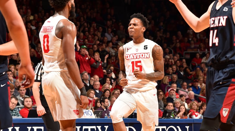 Dayton’s John Crosby (15) and Josh Cunningham celebrate a play against Penn on Saturday, Dec. 9, 2017, at UD Arena. Erik Schelkun/Elestar Images