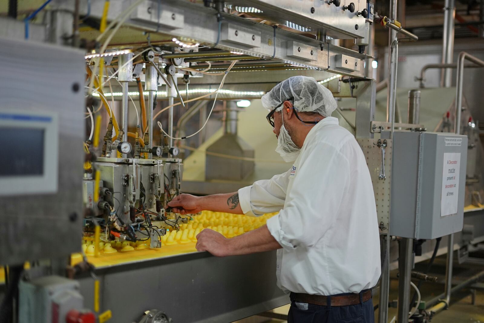 A worker monitors Peeps marshmallow treats as they move through the manufacturing process at the Just Born factory in Bethlehem, Pa., Thursday, April 10, 2025. (AP Photo/Matt Rourke)