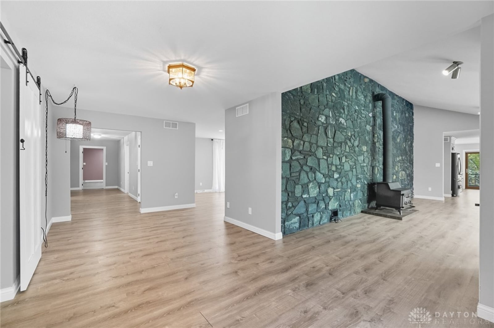 The foyer opens to a sitting room with a greenhouse window area. LVT flooring flows throughout this area. CONTRIBUTED