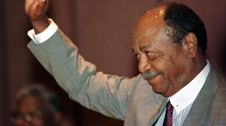 Former Indians star Larry Doby waves to a standing ovation at an All-Star luncheon in his honor in Cleveland on Wednesday, July 2, 1997. Doby broke the color barrier in the American League when he pinch-hit for the Cleveland Indians against Chicago at Comiskey Park. (AP Photo/Piet van Lier)