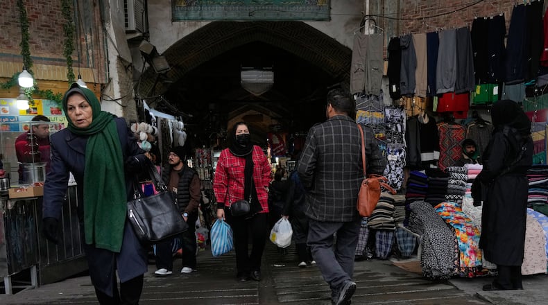 People walk at Tehran's historic Grand Bazaar, Tuesday, Jan. 20, 2026, in Iran. (AP Photo/Vahid Salemi)