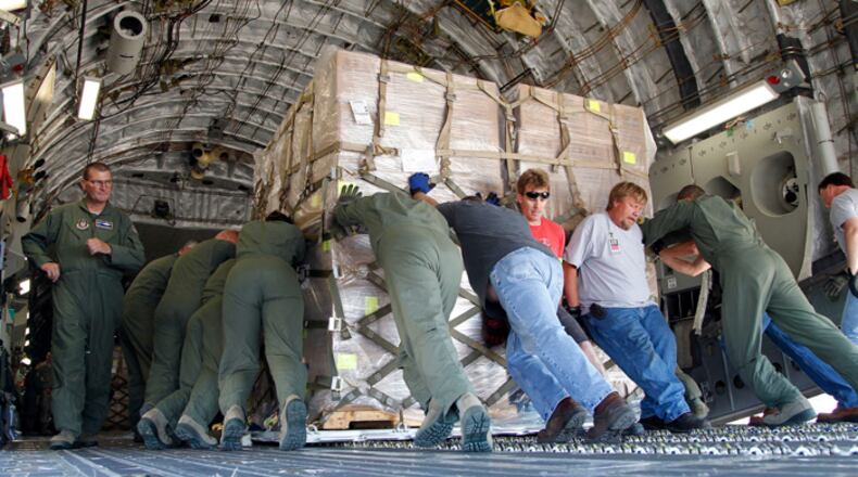 The 445th Airlift Wing at Wright-Patterson Air Force Base loaded more than half-a-million prepackaged meals onto a C-17 bound for Haiti on Friday, June 14. Loadmasters pushed the giant cargo palets of food onto the jet. TY GREENLEES / STAFF