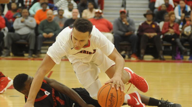 Wayne’s L’Christian Smith (top) falls over Trotwood’s Myles Belyeu. Wayne defeated visiting Trotwood-Madison 82-61 in a boys high school basketball GWOC crossover game on Tuesday, Jan. 26, 2016. MARC PENDLETON / STAFF