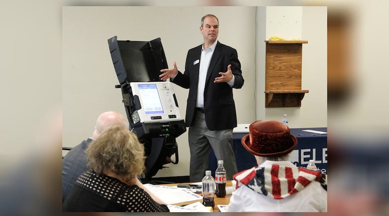 Craig Seibert, regional sales manager, from Election Systems & Software demonstrates a voting machine to the Greene County Board of Elections in Xenia. Dominion Voting Systems machines were demonstrated in a later session. TY GREENLEES / STAFF