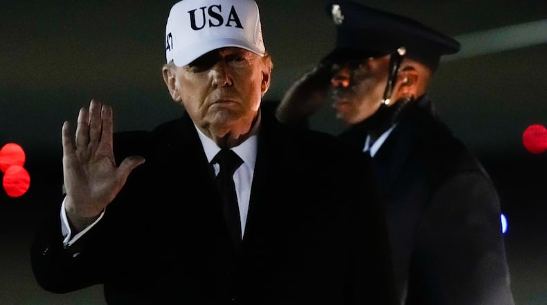 President Donald Trump waves after arriving on Air Force One from Florida, Sunday, Jan. 11, 2026, at Joint Base Andrews, Md. (AP Photo/Julia Demaree Nikhinson)