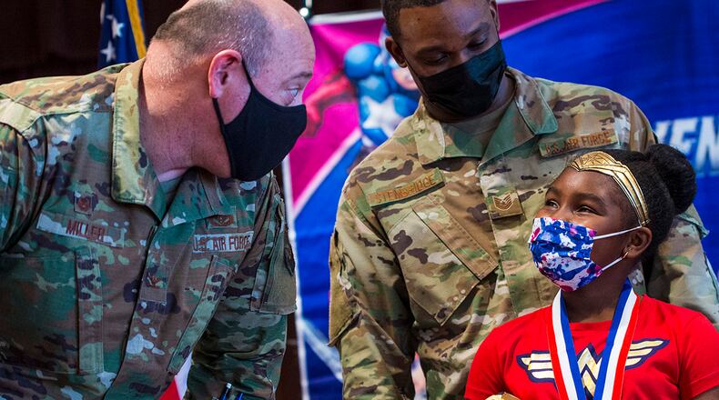 Col. Patrick Miller, 88th Air Base Wing and installation commander, speaks to a child during the Little Heroes event held on Nov. 5 to honor children of deployed parents at Wright-Patterson Air Force Base, Ohio. U.S. AIR FORCE PHOTO/JAIMA FOGG