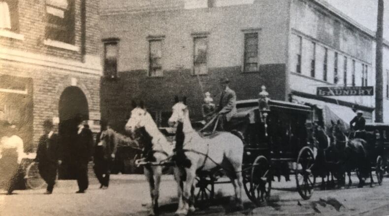 The body of 21 year old Luther McCarty was in the hearse that was drawn by two white stallions and paraded through the streets of Piqua. Some 10,000 people came to vuew the body at the wake and/or followed the hearse to Forest Hill Cemetery in Piqua. The two horses, which were used by McCarty s dad to pull his medince show wagon, were the only possessions saved when the Great Miami River in Piqua flooded its banks in the Great Flood of 1913 and wiped away the family home on Water Street. PHOTO COURTESY OF PIQUA PUBLIC LIBRARY