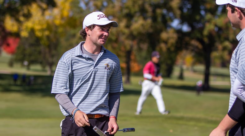 Alter senior Grant Tabar (right) leads the charge to the green to congratulate teammate Davis Gochenouer after he sunk his final putt to celebrate Gochenour's Division II individual championship and the Knights' team championship Saturday at the Ohio State Scarlet Course. CONTRIBUTED/Jeff Gilbert
