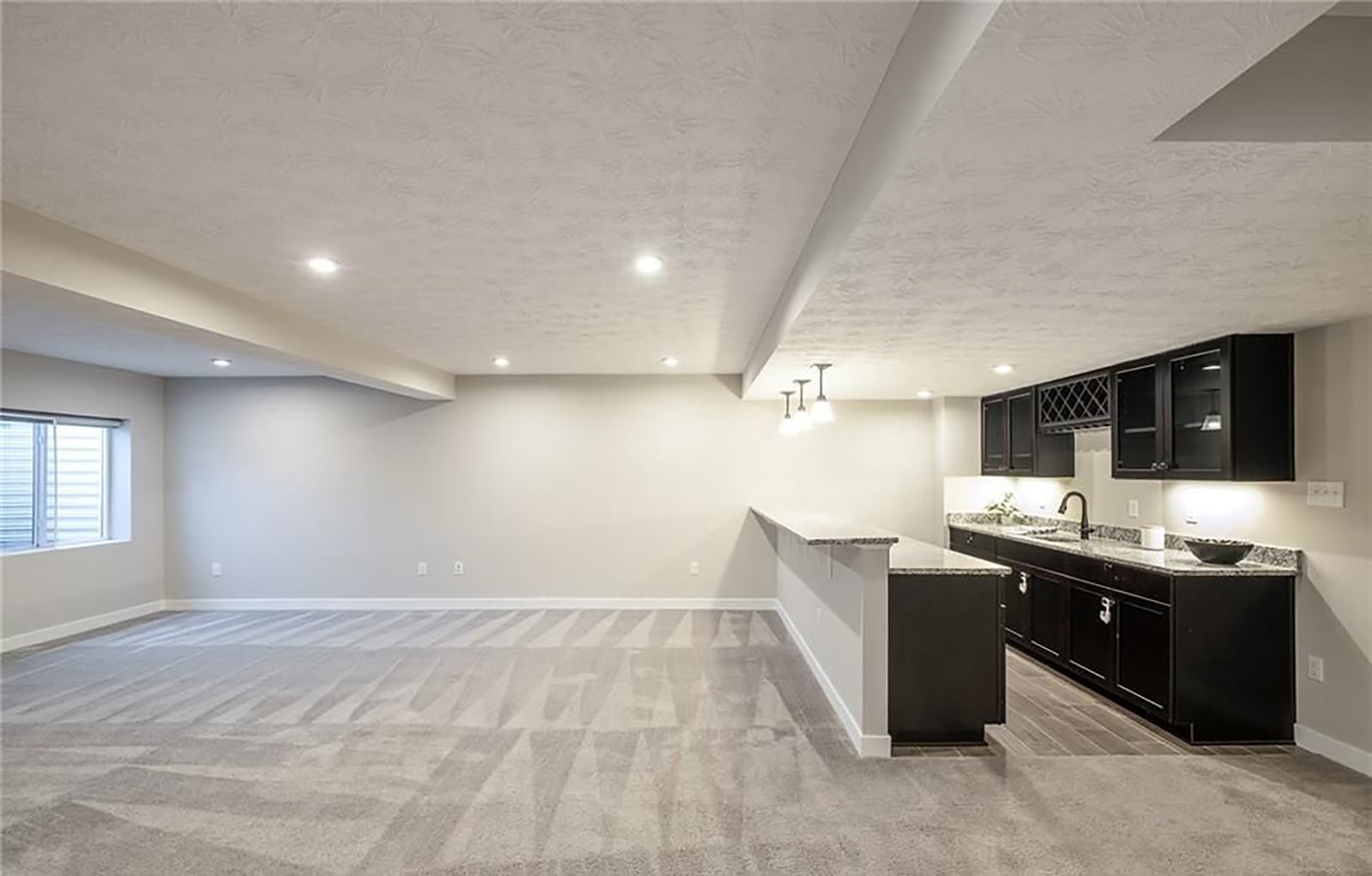 The finished basement has a recreation room with carpeting and a wet bar. It also has recessed lighting and a daylight window. CONTRIBUTED