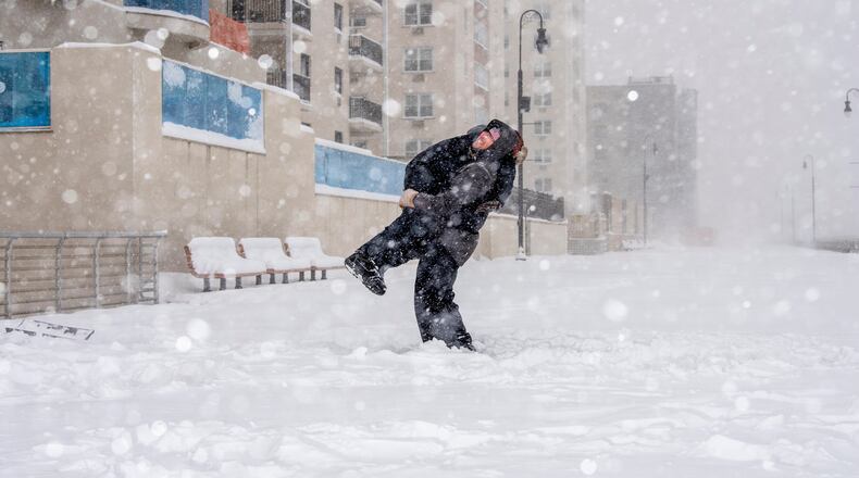 A father and son play in a snow storm in Long Beach, N.Y., Jan. 29, 2022. (Johnny Milano/The New York Times)