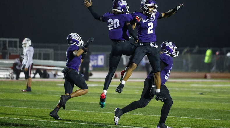 Middletown's Harlem Coleman (20) and Ace Cooper (2) celebrate their Division I Regional football final win against Wayne Friday, Nov. 21, 2025 at Trotwood Madison High School. Middletown won 21-14 to advance. NICK GRAHAM/STAFF