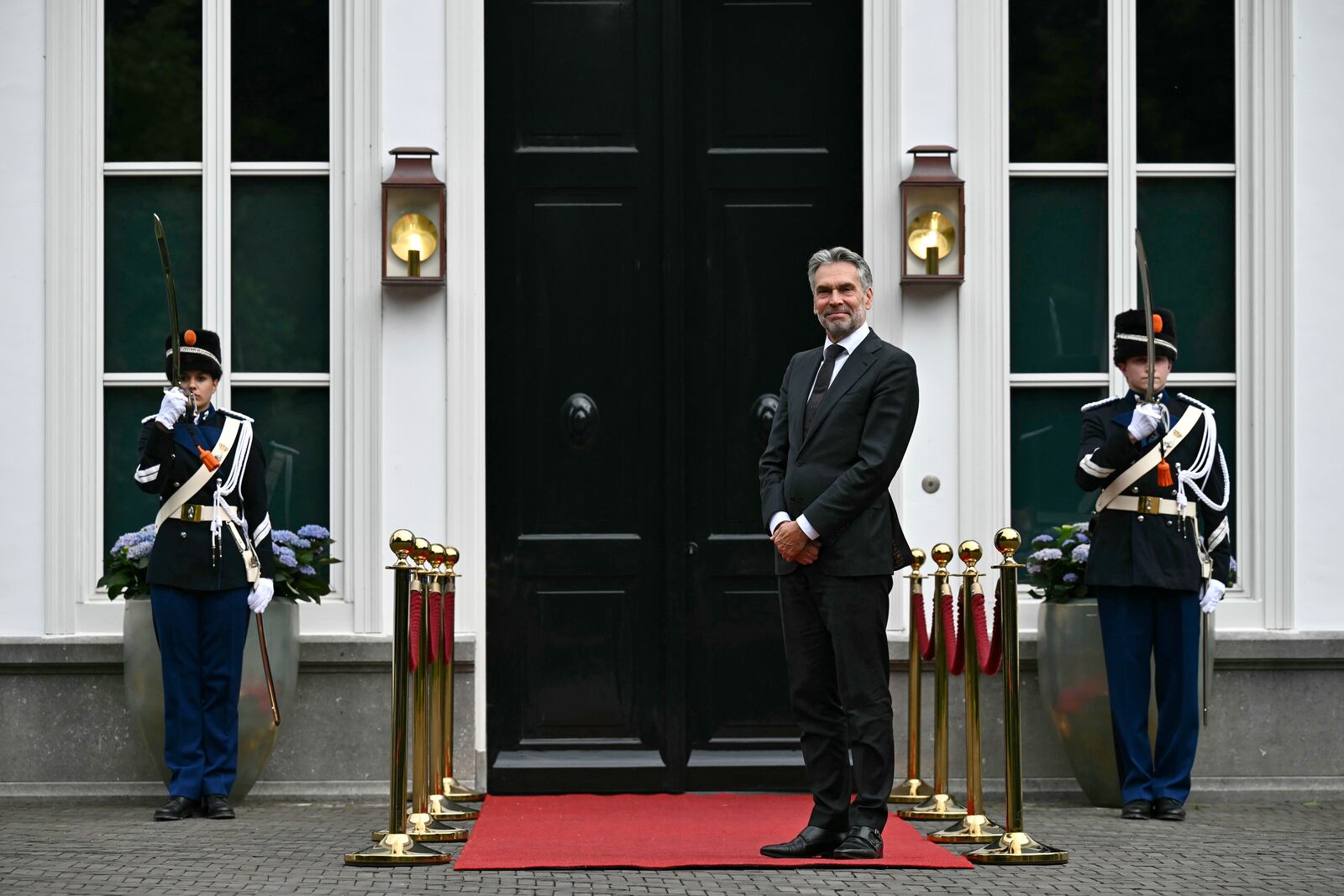 Netherlands' Prime Minister Dick Schoof, right, waits to welcome Britain's Prime Minister Keir Starmer during their meeting on the sidelines of a North Atlantic Treaty Organization (NATO) Heads of State and Government summit in The Hague, Tuesday, June 24, 2025. (Ben Stansall/Pool Photo via AP)