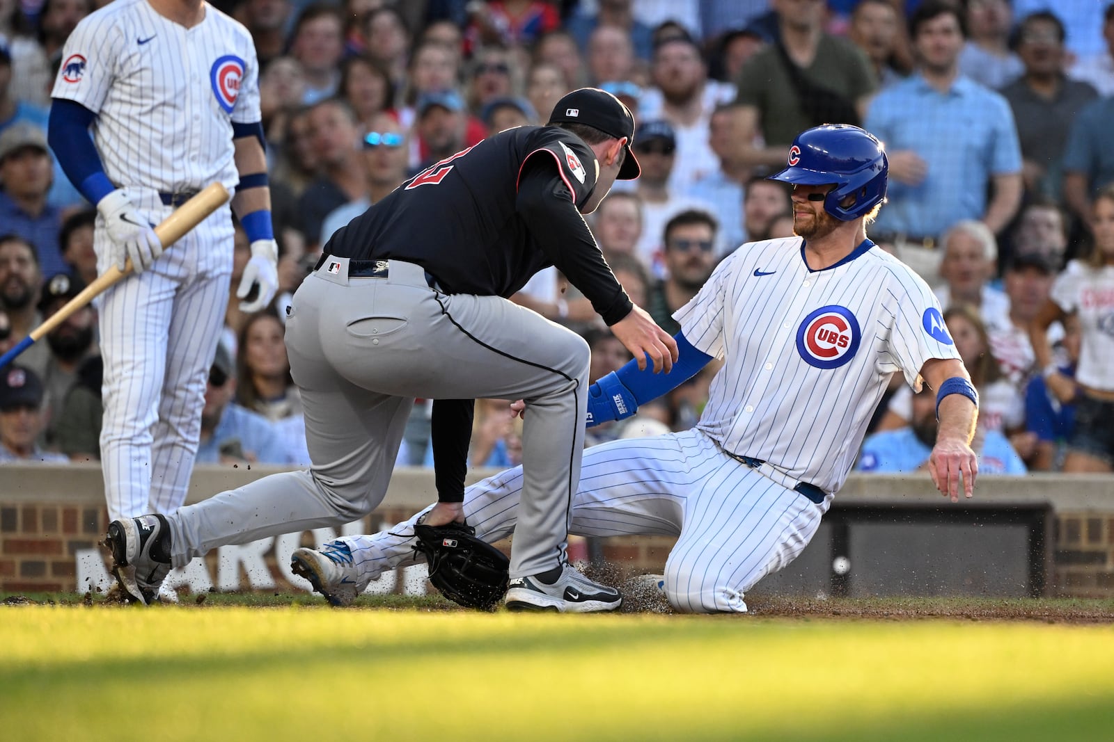 Chicago Cubs' Carson Kelly is tagged out at home plate by Cleveland Guardians catcher Bo Naylor during the second inning of a baseball game, Tuesday, July 1, 2025, in Chicago. (AP Photo/Matt Marton)