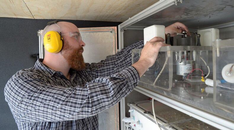 Chase Nau-Hix, a doctoral student at Clarkson University, adjusts settings on the plasma reactor between demonstrations at Wright-Patterson Air Force Base Sept. 25. Nau-Hix was part of the team from Clarkson University and GSI Environmental who travelled to Wright-Patt to demonstrate their Enhanced Contact Plasma Reactor. The plasma reactor is designed to degrade and destroy perfluorooctane sulfonate and perfluorooctanoic acid, known as PFOS and PFOA, in groundwater. This research was funded by the Air Force Civil Engineer Center. (U.S. Air Force photo/John Van Winkle)