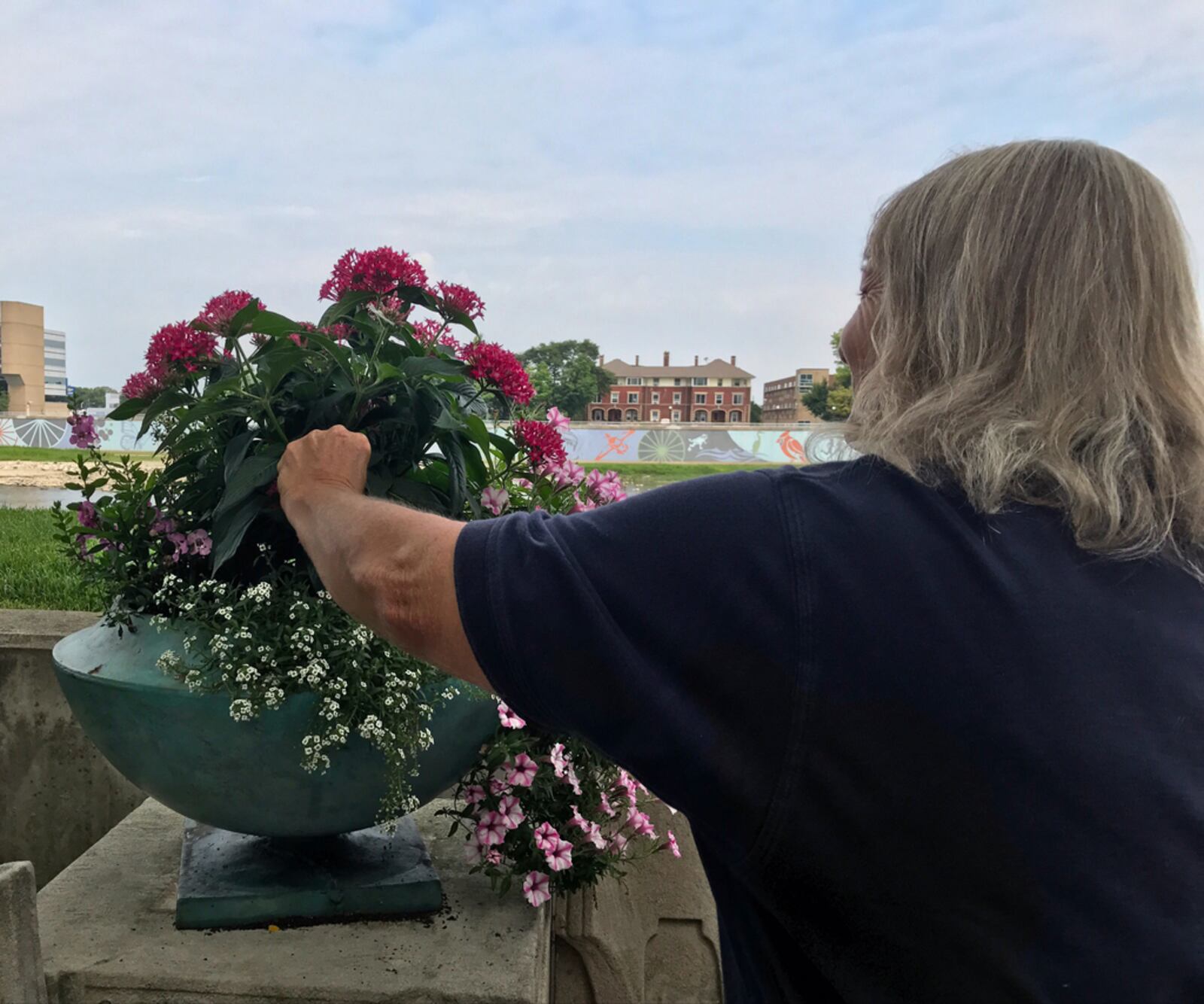 Cinda Plante adjusts a flower arrangement at Riverscape Metropark.
