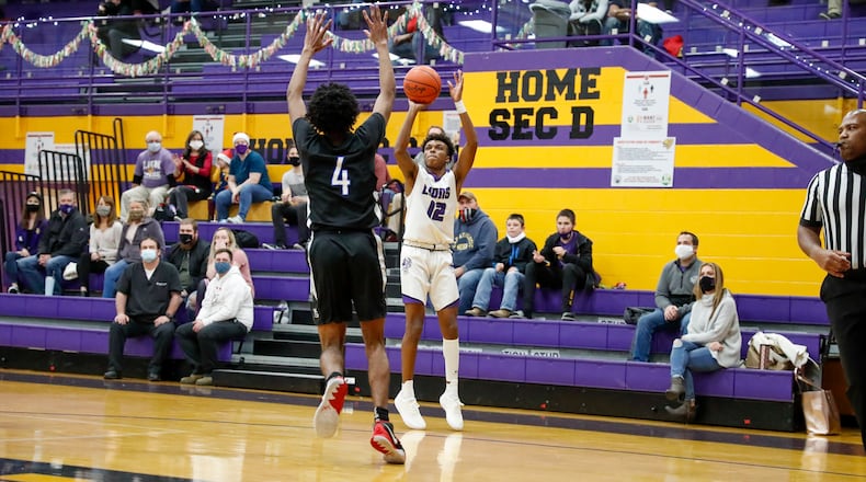 Emmanuel Christian Academy senior Jason Channels shoots the ball over Yellow Springs' Javas McNair during their game on Tuesday, Dec. 15. Channels and his brother Justus are two of the top scorers in the Metro Buckeye Conference this season. Michael Cooper/CONTRIBUTED