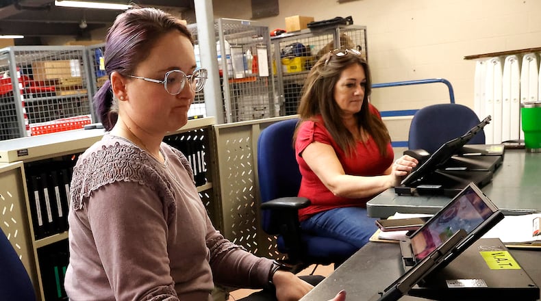 Brittany Kensler, left, and Pattie Fuschino were busy updating the epoll books for the upcoming election Thursday, April 6, 2023, at the Clark County Board of Elections. BILL LACKEY/STAFF