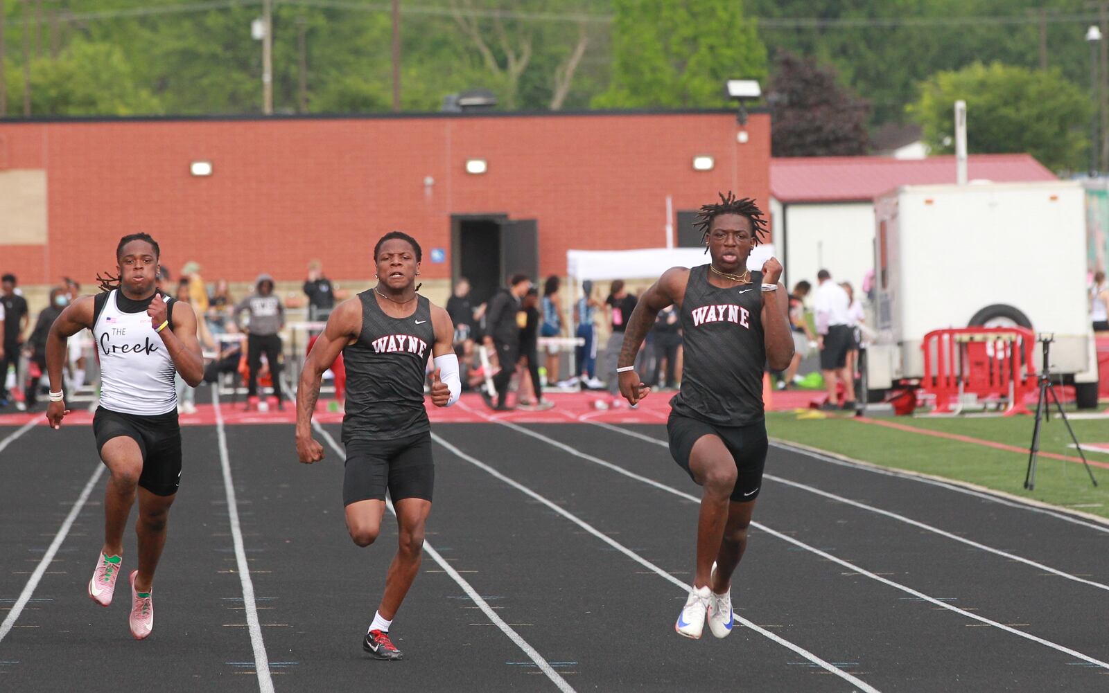 Jamier Averette-Brown (right) of Wayne edges teammate Semarion Stroufe in the 100-meter dash at the 2025 GWOC track meet at Heidkamp Stadium in Huber Heights on May 14.
