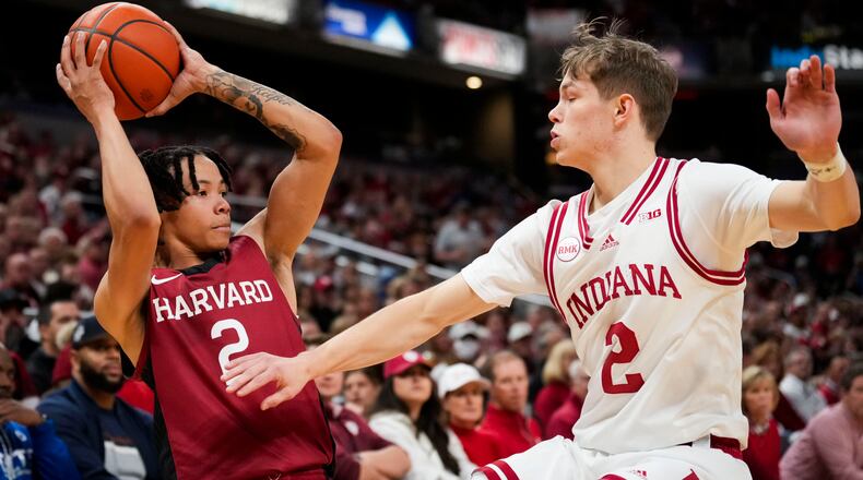 FILE - Harvard guard Malik Mack, left, looks to pass the ball around Indiana guard Gabe Cupps, right, in the first half of an NCAA college basketball game in Indianapolis, Nov. 26, 2023. (AP Photo/AJ Mast, File)