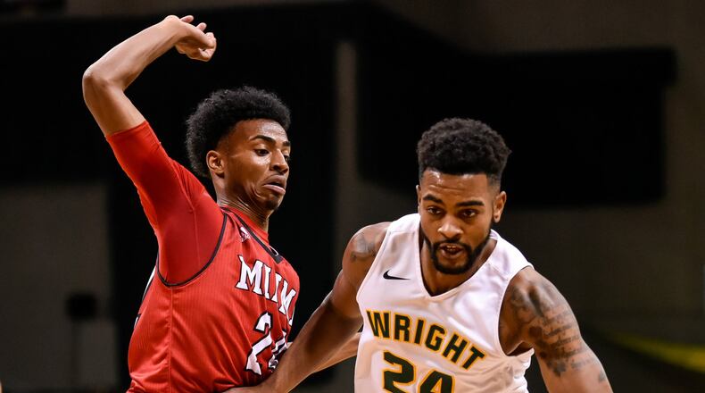 Wright State University’s Mark Alstork dribbles down court defended by Miami Univeristy’s Michael Weathers during the first half of their game against Tuesday, Nov. 15 at the Nutter Center at Wright State University in Fairborn. NICK GRAHAM/STAFF
