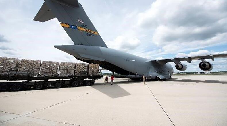 Airmen with the 15th Airlift Squadron out of Joint Base Charleston, and the 88th Logistics Readiness Squadron, load humanitarian aid onto a C-17 Globemaster III at Wright-Patterson Air Force Base Aug. 23. The humanitarian mission delivered 50 tons of food and water to Port-au-Prince, Haiti. (U.S. Air Force photos/Michelle Gigante)