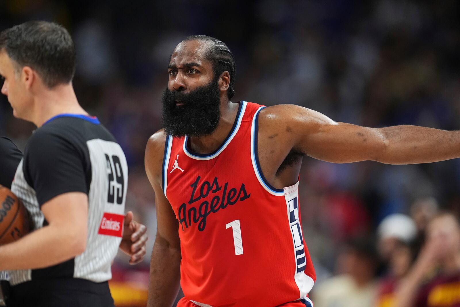 Los Angeles Clippers guard James Harden, right, argues after being called for a foul by referee Mark Lindsay, left, in overtime of Game 1 of an NBA first-round playoff series against the Denver Nuggets, Saturday, April 19, 2025, in Denver. (AP Photo/David Zalubowski)