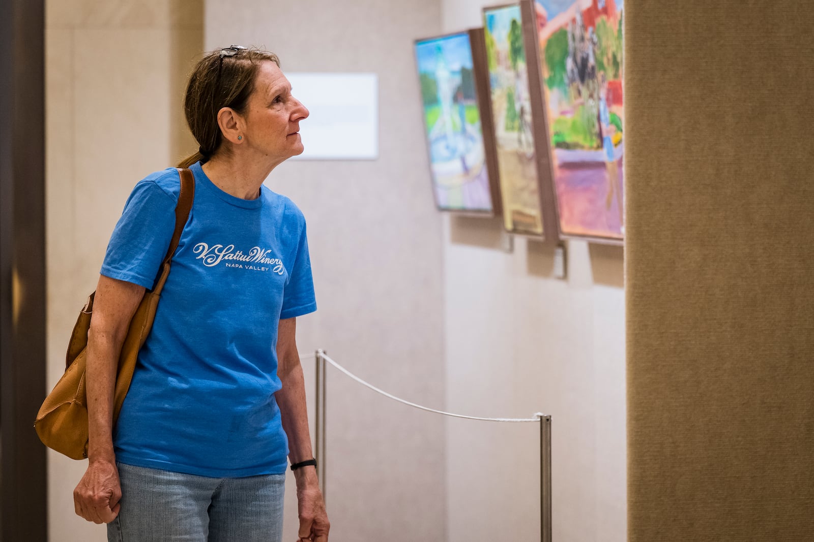 A visitor looks at an exhibit of paintings by President George W. Bush on display at the George W. Bush Presidential Museum on Thursday, May 15, 2025, in Dallas. (AP Photo/Jessica Tobias)