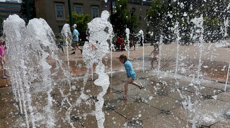 A young girl plays in the fountain at RiverScape MetroPark in downtown Dayton on Sunday, July 9, 2023. CORNELIUS FROLIK / STAFF